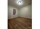 Bright bedroom with wood-look floors and window coverings at 648 Scotts Creek Rd, Statesville, NC 28625