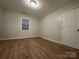 Simple bedroom with light walls, wood-look floors, and a large closet at 648 Scotts Creek Rd, Statesville, NC 28625