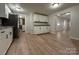 Bright kitchen featuring white cabinets, granite countertops, and a view into the living area at 648 Scotts Creek Rd, Statesville, NC 28625