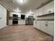 Modern kitchen with white cabinets, granite countertops, and stainless steel appliances at 648 Scotts Creek Rd, Statesville, NC 28625