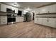 Modern kitchen with white cabinets and stainless steel appliances at 648 Scotts Creek Rd, Statesville, NC 28625