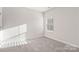 Well-lit bedroom with carpet flooring and window at 8715 Pennegrove Cir, Charlotte, NC 28214