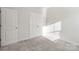 Simple bedroom with double door closet and carpet flooring at 8715 Pennegrove Cir, Charlotte, NC 28214