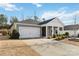 Gray house with white accents, two car garage, and landscaping at 8715 Pennegrove Cir, Charlotte, NC 28214