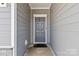 Gray front door entryway with stone accents at 8715 Pennegrove Cir, Charlotte, NC 28214