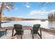 Serene lakefront setting with Adirondack chairs, ideal for relaxation at 8715 Pennegrove Cir, Charlotte, NC 28214