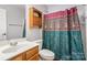 Clean bathroom with wood vanity, shower, and decorative curtain at 9325 Four Mile Creek Rd, Charlotte, NC 28277