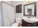 Cozy bathroom featuring a vanity, wall cabinet, toilet, and shower with neutral colors at 9325 Four Mile Creek Rd, Charlotte, NC 28277