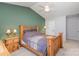 Bedroom featuring a ceiling fan, green accent wall, and wood furniture at 9325 Four Mile Creek Rd, Charlotte, NC 28277