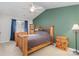 Main bedroom with wood bed frame and green accent wall at 9325 Four Mile Creek Rd, Charlotte, NC 28277