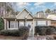 Tan house with white door, landscaping, and black shutters at 9325 Four Mile Creek Rd, Charlotte, NC 28277