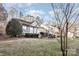 House exterior showcasing a tan home with landscaping, and a yard at 9325 Four Mile Creek Rd, Charlotte, NC 28277