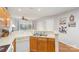 Kitchen featuring wooden cabinets, white appliances, and a view into the dining area at 9325 Four Mile Creek Rd, Charlotte, NC 28277