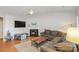 Comfortable living room featuring a fireplace, ceiling fan, and a large sectional sofa at 9325 Four Mile Creek Rd, Charlotte, NC 28277