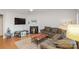 Living room with fireplace, sectional sofa, and hardwood floors at 9325 Four Mile Creek Rd, Charlotte, NC 28277