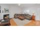 Living room featuring a fireplace, sectional sofa, and hardwood floors at 9325 Four Mile Creek Rd, Charlotte, NC 28277