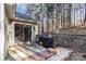 Private backyard patio with grill and wooded view at 9325 Four Mile Creek Rd, Charlotte, NC 28277