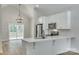 Modern kitchen with white cabinets, quartz countertops, and stainless steel appliances at 936 Jackson Rd, Fort Lawn, SC 29714