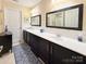 Double vanity bathroom with dark wood cabinets and marble tile at , Charlotte, NC 28269