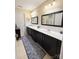 Double vanity bathroom with marble tile and dark cabinets at 5559 Prosperity View Dr, Charlotte, NC 28269