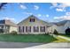 Quaint yellow house with maroon shutters, a porch, and a well-maintained lawn at 10117 Bishops Gate Blvd, Pineville, NC 28134