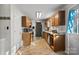 Kitchen with wood cabinets, granite countertops, and a view to dining area at 1013 Ashwood Pl, Salisbury, NC 28146