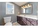 Bathroom with vanity, toilet, and mirror at 102 Hickory St, Locust, NC 28097