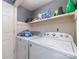 Laundry room with washer, dryer, and shelving at 102 Hickory St, Locust, NC 28097