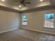 Bright bedroom with carpet, ceiling fan, and two windows at 104 Kerr Walk Dr # 14, Statesville, NC 28677