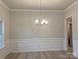 Bright dining room with hardwood floors, chandelier, and wainscoting at 104 Kerr Walk Dr # 14, Statesville, NC 28677