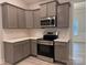 Modern kitchen with gray cabinets, quartz countertops and stainless steel appliances at 104 Kerr Walk Dr # 14, Statesville, NC 28677