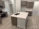 Modern kitchen with gray cabinets, quartz countertops, and an island at 104 Kerr Walk Dr # 14, Statesville, NC 28677