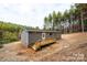 Gray mobile home with a deck and stairs in the woods at 114 River Ridge Ln, Hickory, NC 28601