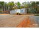 Gray mobile home on a hillside with stairs and wooded surroundings at 114 River Ridge Ln, Hickory, NC 28601