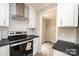 Modern kitchen featuring white cabinets and a stainless steel range at 114 River Ridge Ln, Hickory, NC 28601