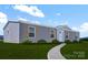 Ranch-style home with gray siding, wood shutters, and a paved pathway at 116 River Ridge Ln, Hickory, NC 28601