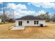 An inviting backyard space featuring a newly installed concrete patio and well kept home exterior at 1200-1 Stanton Dr, Shelby, NC