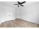 A modern bedroom with a ceiling fan, closet, and neutral color scheme at 1200-1 Stanton Dr, Shelby, NC