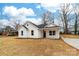 Beautiful white home featuring dark trim, a manicured lawn, and a welcoming front porch at 1200-1 Stanton Dr, Shelby, NC