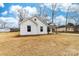 Attractive white home boasting dark trim, a well-maintained lawn, and a cozy front porch at 1200-1 Stanton Dr, Shelby, NC