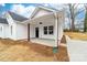 A beautiful white home with a charming front porch and well-maintained landscaping at 1200-1 Stanton Dr, Shelby, NC