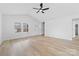 Bright living room features wood floors, a ceiling fan, a front door, and windows at 1200-1 Stanton Dr, Shelby, NC