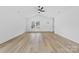 Bright living room with wood floors, ceiling fan, and a view of the front yard at 1200-1 Stanton Dr, Shelby, NC