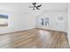 Bright living room featuring wood floors, ceiling fan, and front yard view through windows at 1200-1 Stanton Dr, Shelby, NC