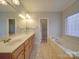 Bathroom boasts double sinks, a jetted tub, and tiled floors at 121 Sierra Woods Dr, Troutman, NC 28166