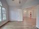 Light-filled bedroom with hardwood floors and access to another room at 121 Sierra Woods Dr, Troutman, NC 28166