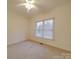 Well-lit bedroom with carpet, window with blinds, and ceiling fan at 121 Sierra Woods Dr, Troutman, NC 28166