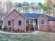 Brick house with a gray roof, walkway, and landscaping at 121 Sierra Woods Dr, Troutman, NC 28166