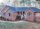 Brick house with a gray roof, and a walkway leading to the front entrance at 121 Sierra Woods Dr, Troutman, NC 28166