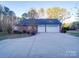 Three car garage with a large driveway at 121 Sierra Woods Dr, Troutman, NC 28166